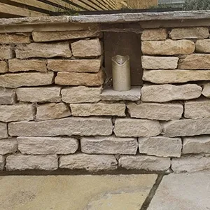 a stone wall with a window in it