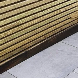 a bench made out of wooden slats on a sidewalk