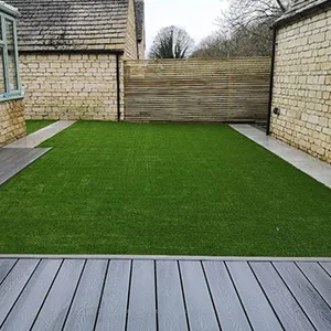 a backyard with a wooden deck and grass