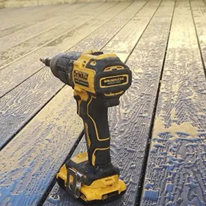 a cordless drill is sitting on a wooden floor