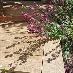 A wooden bench sitting on top of a wooden deck.