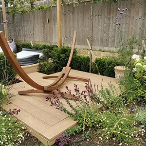 A wooden bench sitting on top of a wooden deck.