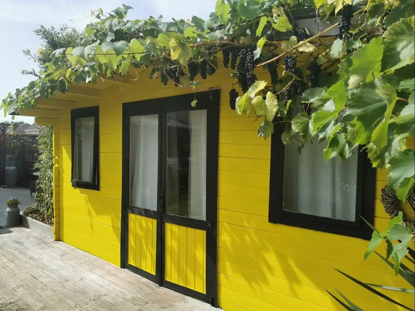a yellow house with black trim and windows
