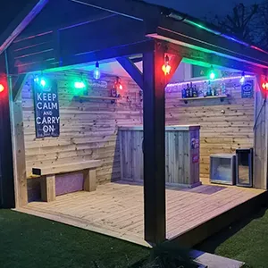 a small wooden building with lights on it