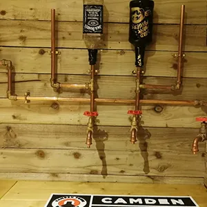 a wooden wall with a bunch of pipes on it